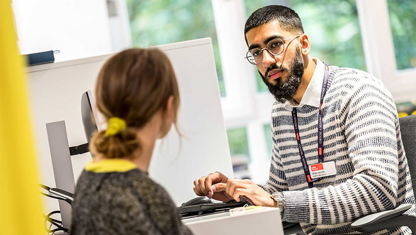 A student Optometrist talking to a patient.