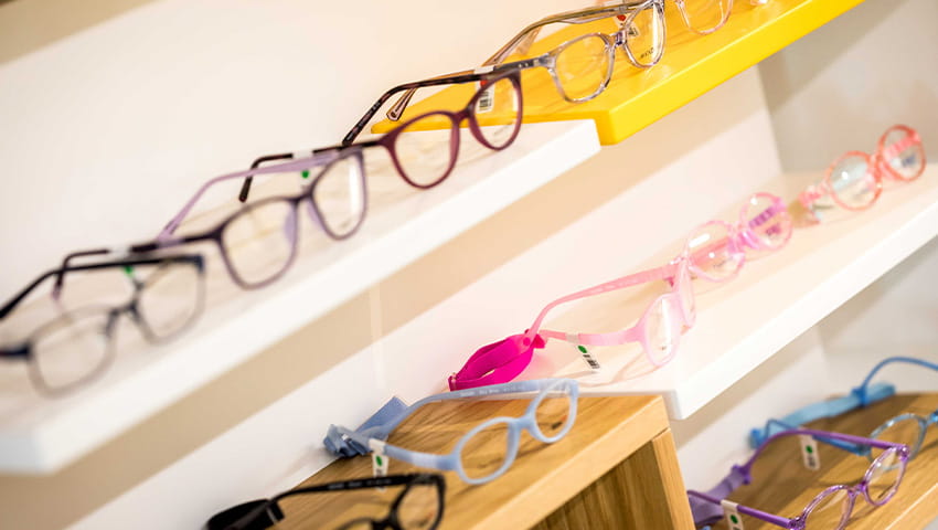 A close-up of glasses on a shelving display.
