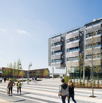 People walking past Bristol Business School building and the Students' Union building on Frenchay Campus