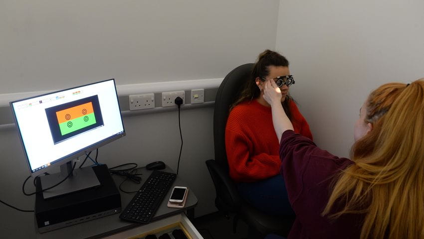 Student using optometry equipment