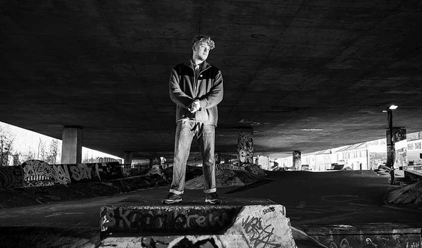 James aka 'FATBAZ' standing on a skate ramp under a motorway