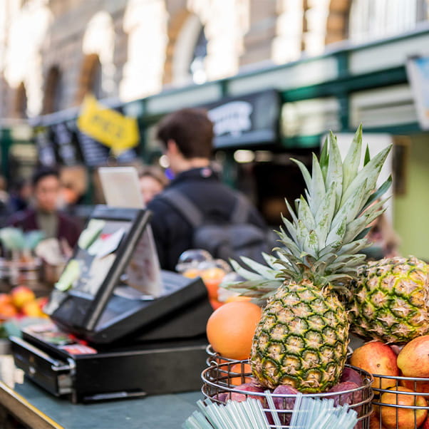 Food stall at St Nick's market displaying bowls of fruit on the counter