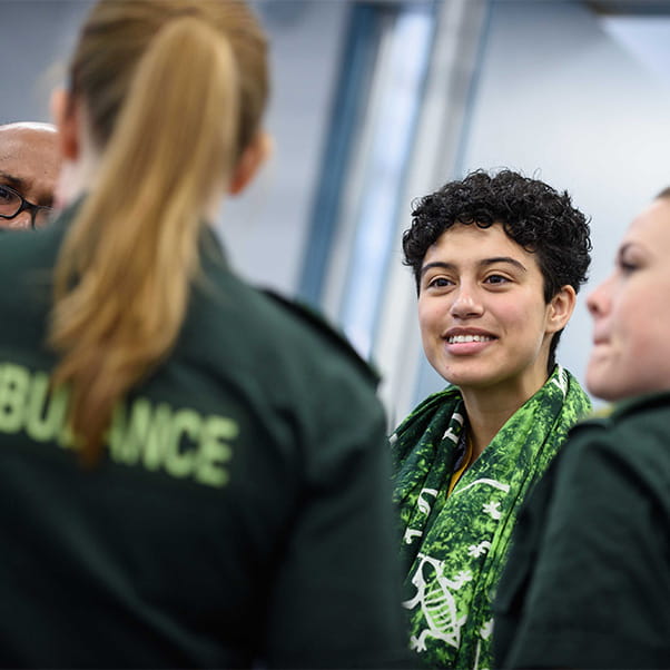 Group of students chatting wearing paramedic uniform