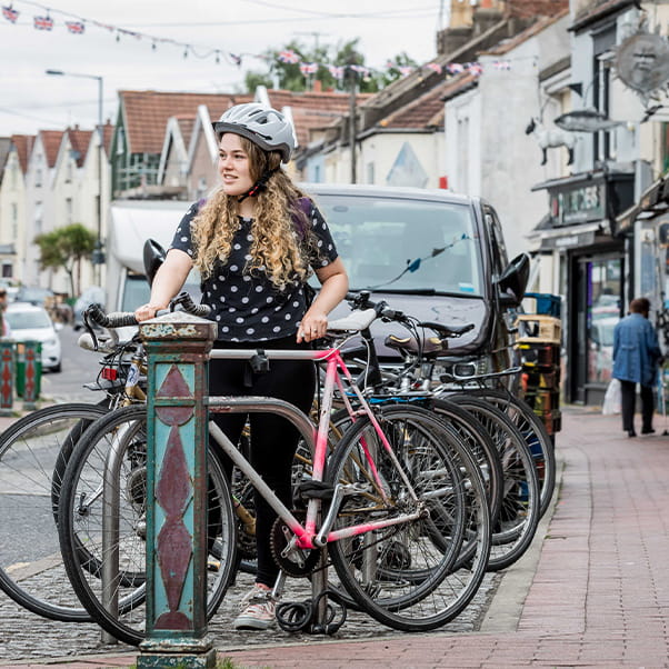 Student wearing helmet getting ready to ride their bicycle in the city