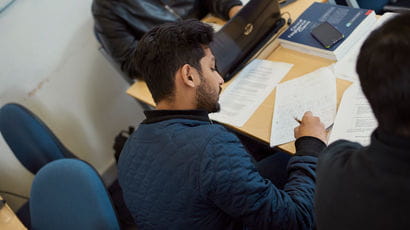 A student writing on a piece of paper