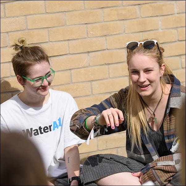 Students chatting in the sun, outside student accommodation