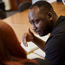 Students having a conversation in a classroom. 