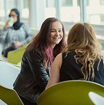 Students having conversations in the cafe on Frenchay Campus.