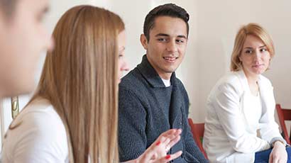 A group of four students in conversation