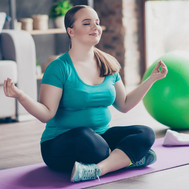 Person doing yoga on a mat.