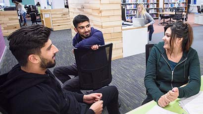Group of students talking in the library