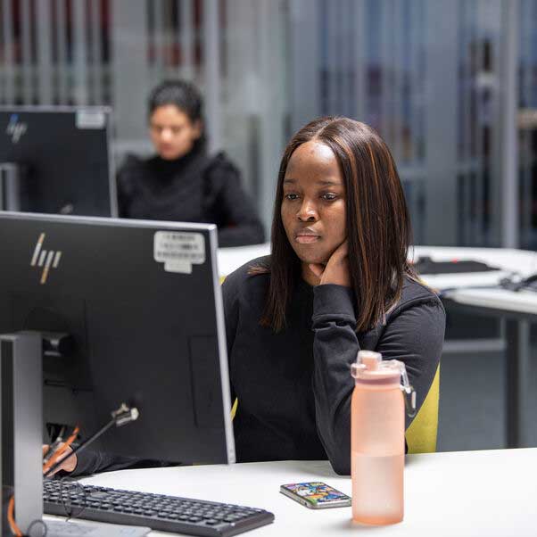 Student looking at a computer monitor.