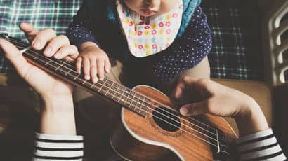 Baby playing a uke