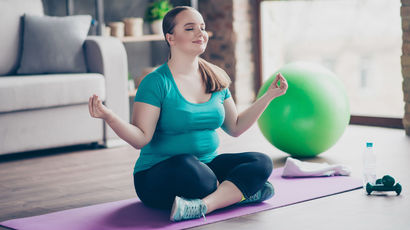Woman meditating with yoga equipment