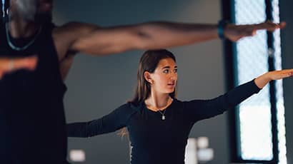 Woman meditating with yoga equipment