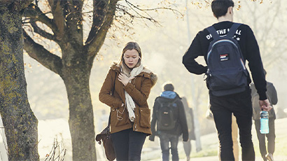 Students walking around campus in cold weather.