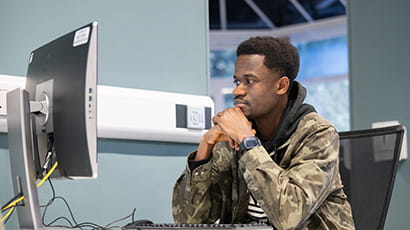 student working on a desktop computer