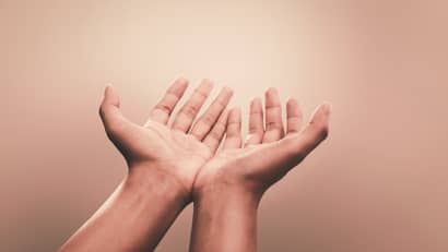 Hands held out in prayer