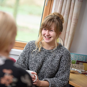 Two students chatting in student room