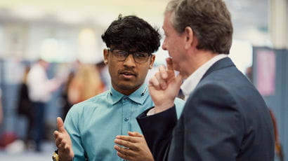 Two people having a conversation at an event