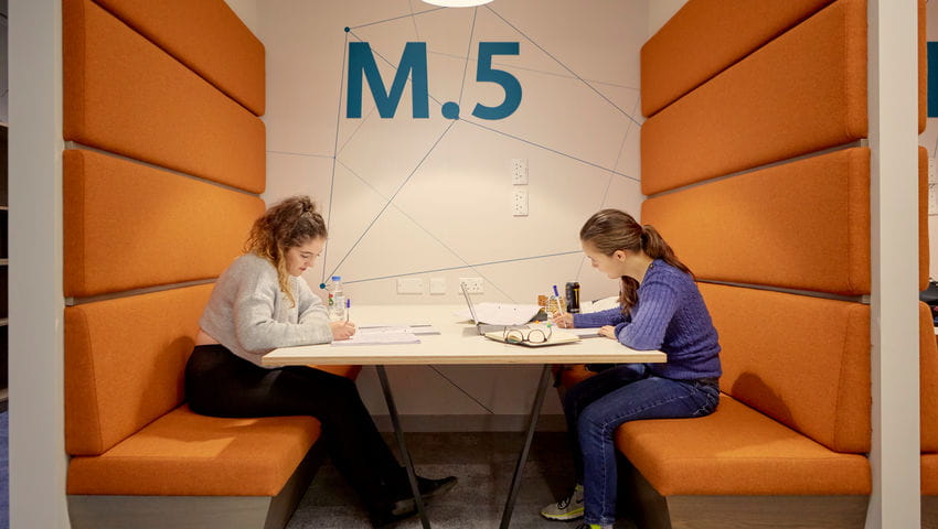 Students sitting in a pod working
