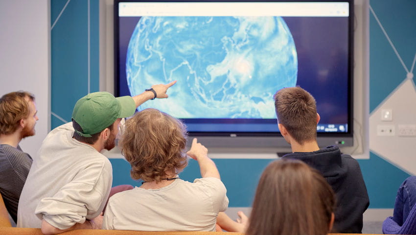 Students using a big monitor in the Maths Hub