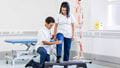 Physiotherapy students practising treatments in modern physio rooms