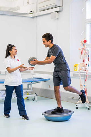 Physio student provides balance training exercises to patient