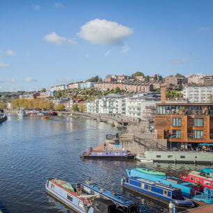 Bristol harbour with boats and colourful houses.