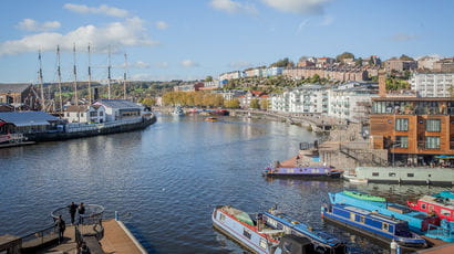 Bristol harbour with boats and colourful houses.
