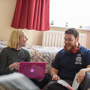 woman and man laughing in a student room