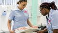 Midwifery students with a dummy in the Skills Simulation Suite on Glenside Campus.