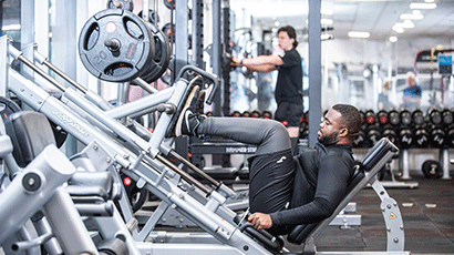 Man working on a gym machine in the Centre for Sport UWE Bristol.