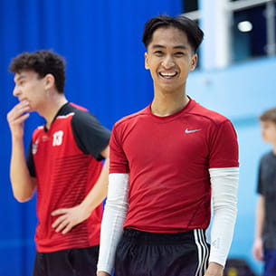 A student in sports clothes smiles to camera during a MOVE session in the Centre for Sport at UWE Bristol.