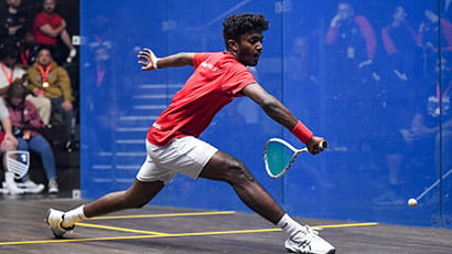 UWE Performance Sport squash player lunging for the ball on court. 