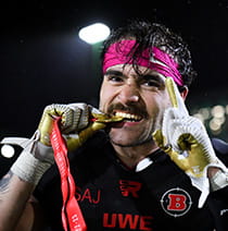 UWE Bristol Performance Sport American Football player bites a gold medal.