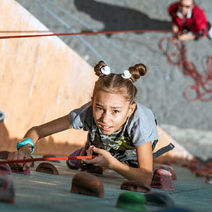 Child using a climbing wall.