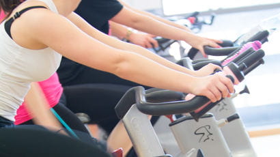 Close up of someone using an exercise bike in Frenchay Campus gym.