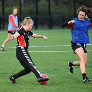 Group of students playing football at Hillside Gardens.