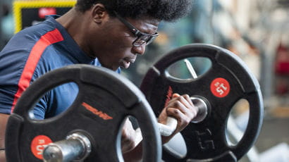 Close up of people's hands using gym equipment.