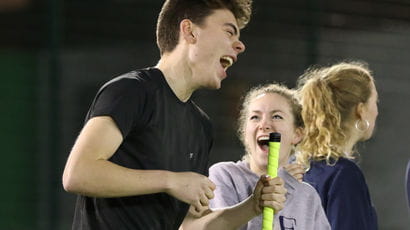 Two students playing hockey on Frenchay Campus.