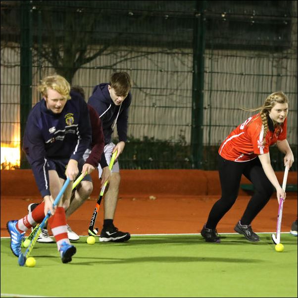Students playing hockey.