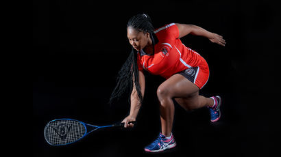 Squash player posing with a racket.
