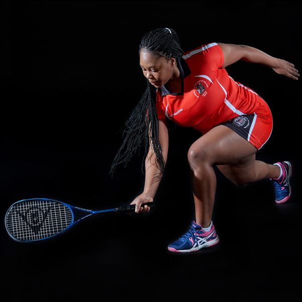 Performance squash student posing with a racket.