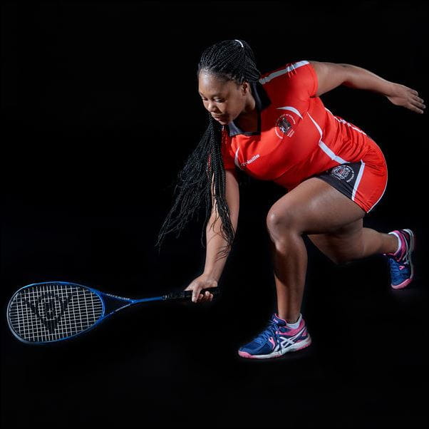 Performance squash student posing with a racket.