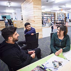 Group of students talking in the library