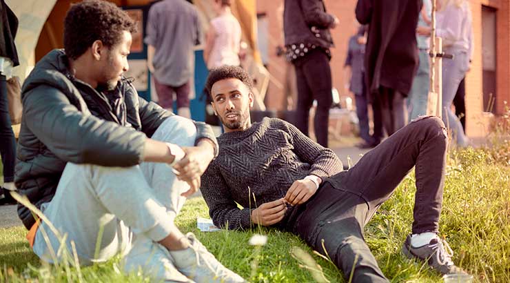 Students relaxing on grass in Bristol