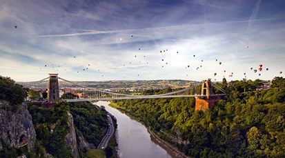 Aerial view of the Bristol Suspension Bridge with hot air balloons