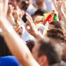 Close up of a group of people with their hands up