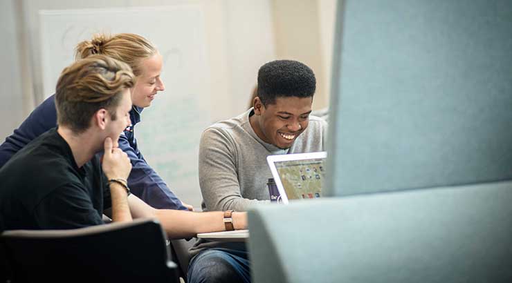 Group of students working in a booth